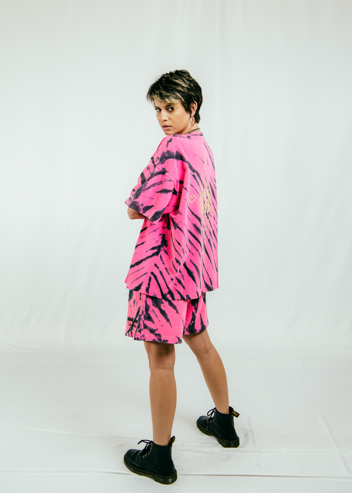 girl standing in matching pink zebra tshirt and shorts set